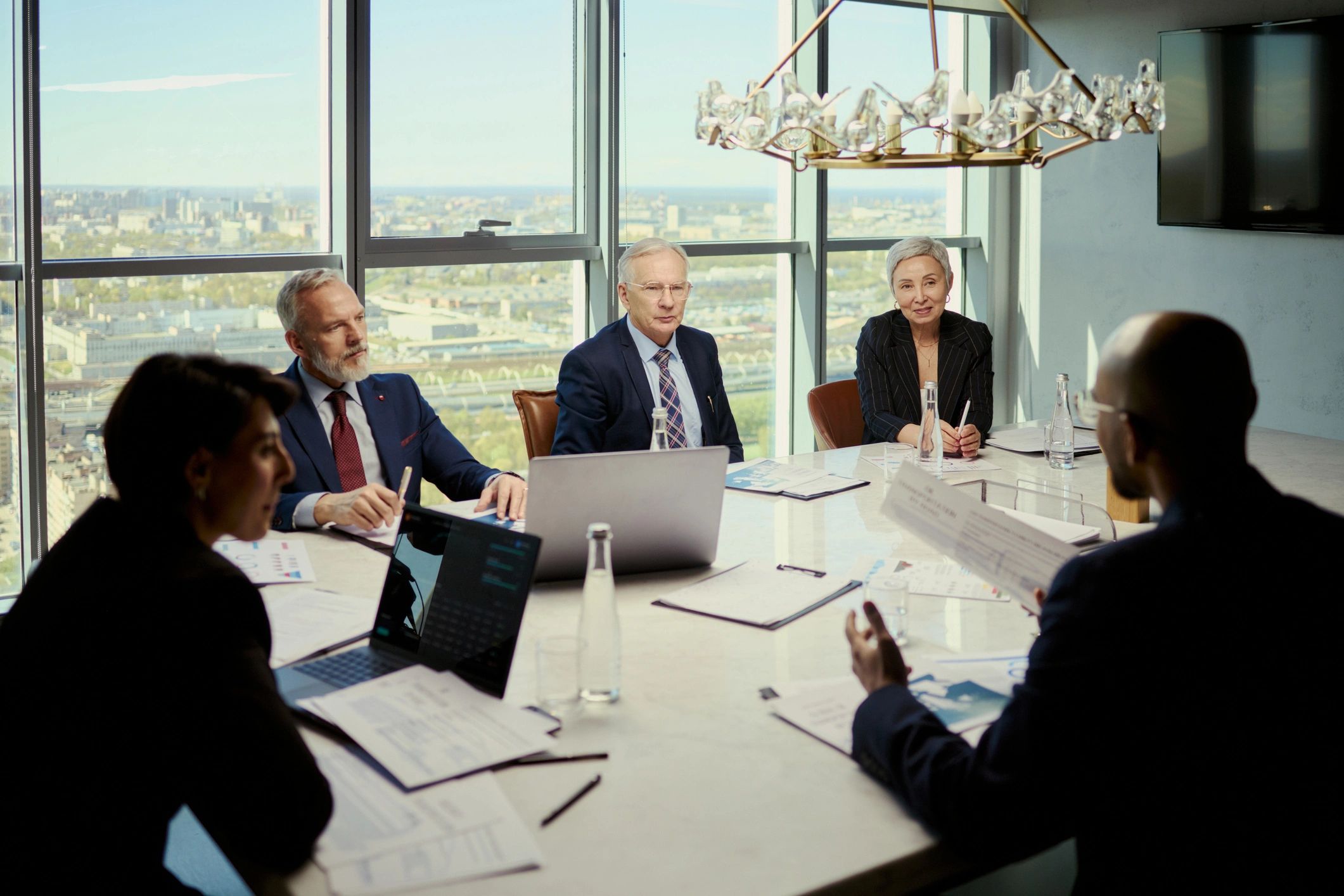 Senior business team discussing strategy in a boardroom